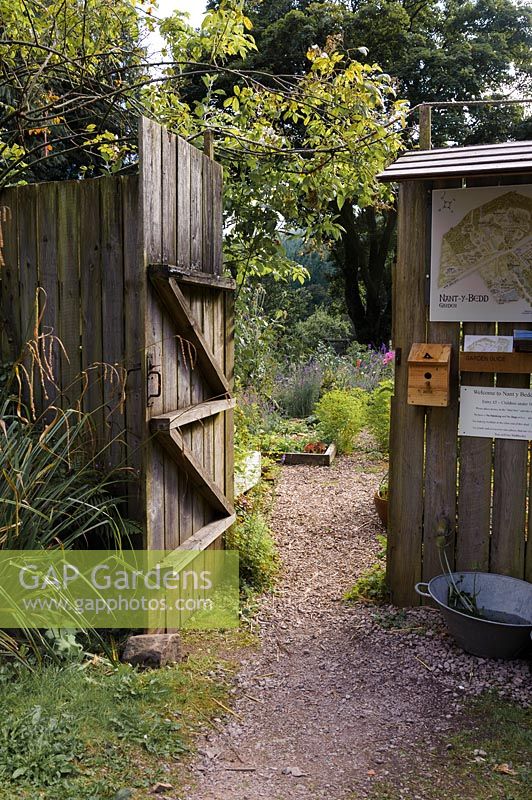 Entrance gate to the garden with map and honesty box. 