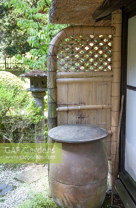 Symbolic barrel beside Tea House with bamboo screen