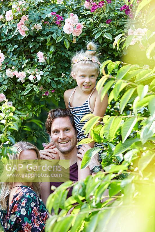 Family together enjoying being in a garden