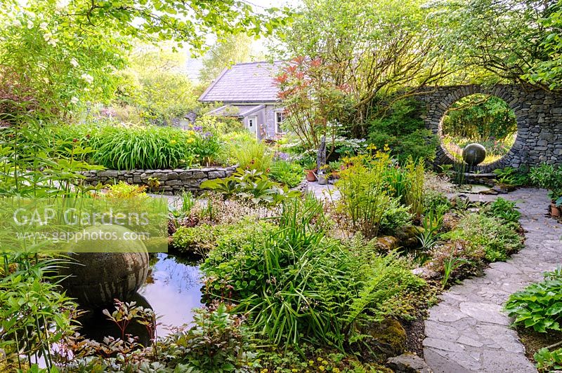 Pond with cast concrete spherical water feature with Moon Window. Fanore, Ireland