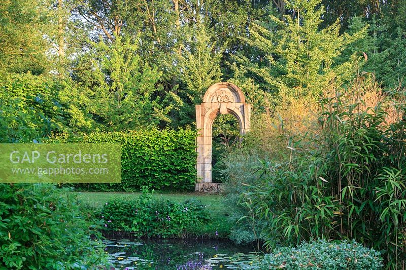 Monumental archway with bamboos and Nuphar lutea- native waterlilies 