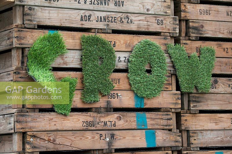 GROW decoration hanging on wooden crates. De Tulperij: Dutch nursery of Daan and Anja Jansze at Voorhout, Holland.