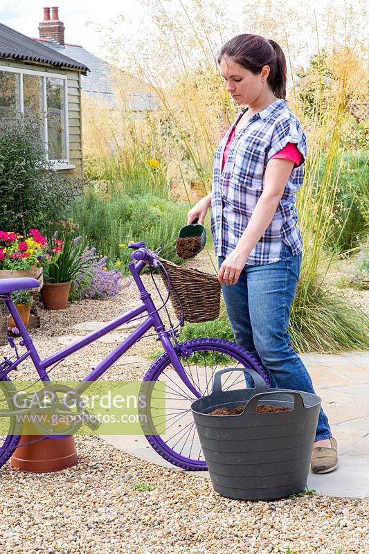 Adding compost to lined basket