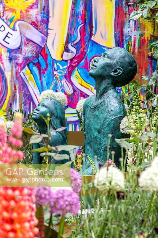 Artisan Garden - The Supershoes, Laced with Hope Garden, sculptures and wall painting with mixed planting - Sponsor: Frosts Garden Centres - RHS Chelsea Flower Show, 2018
