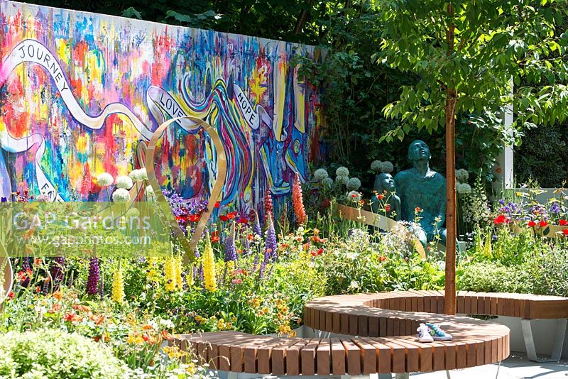 The Supershoes, Laced with Hope Garden, a partnership with Frosts. Sponsor: Frosts Garden Centres, RHS Chelsea Flower Show, 2018. Mural by Karen Huwen. 