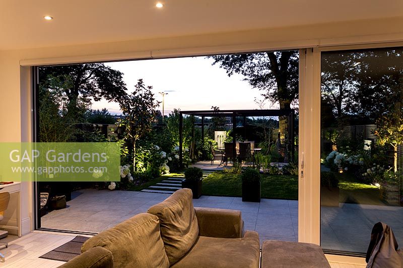 Artificial garden lights from illuminated living area of house