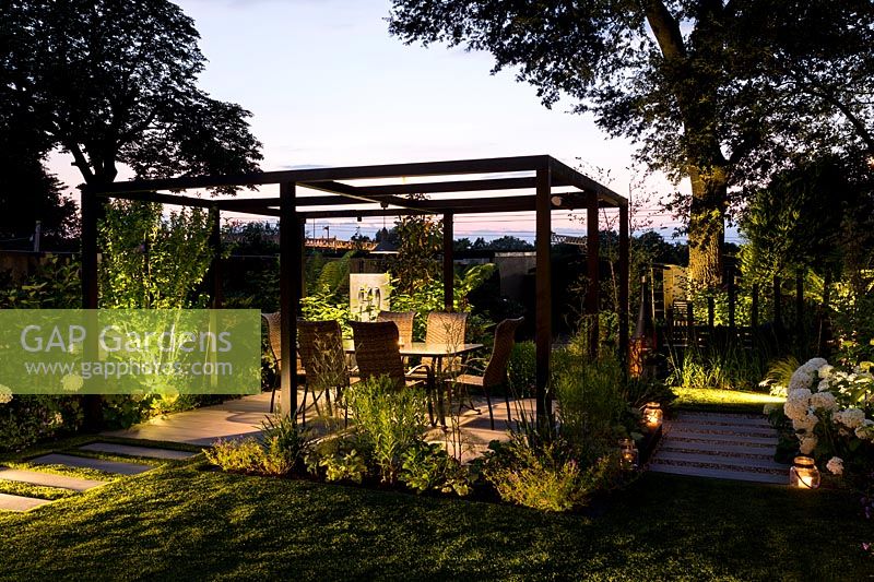 Artificial light with pergola and patio seating.