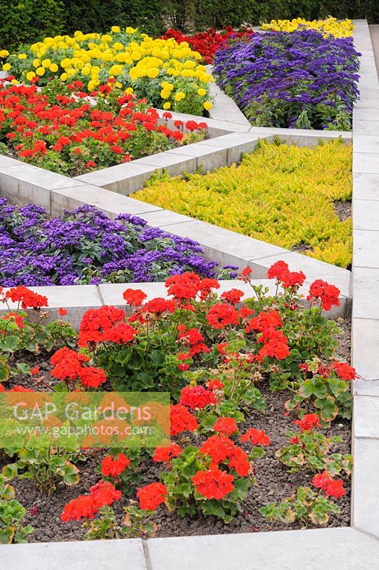 Colour garden representing the stained glass windows in the Lady Chapel in the 
cathedral, in the Bishop's Palace Garden, Wells planted with vivid summer bedding