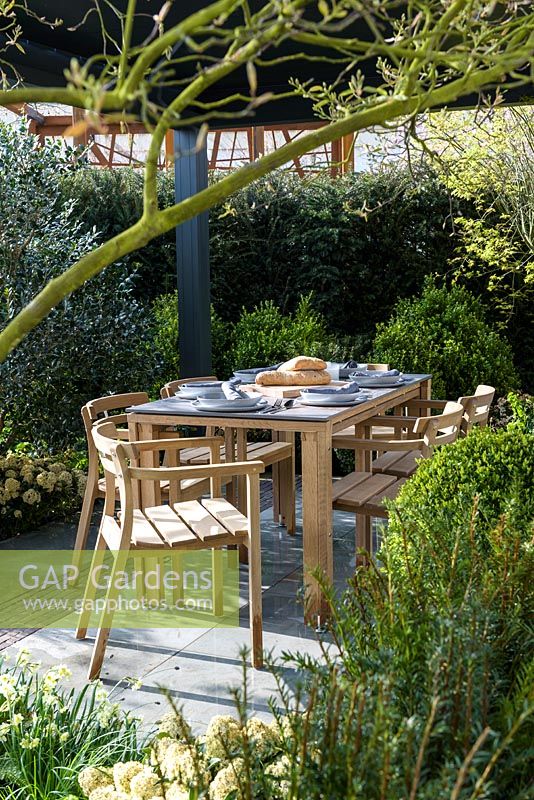 Dining area with wooden  table and chairs - The Landform Spring Garden - Ascot Spring Garden Show, 2018 