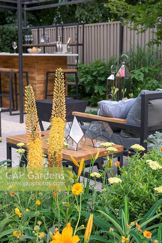 Border next to a contemporary seating area - The Landform Garden Bar, RHS Hampton Court Palace Flower Show 2018