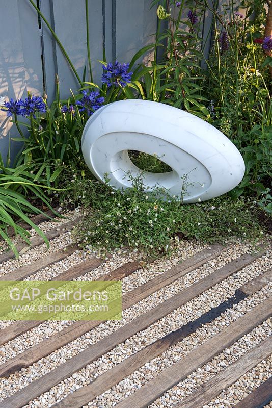 White Carrara Marble sculpture in show garden - Southend Young Offenders' A Place to Think, RHS Hampton Court Palace Flower Show, 2018.