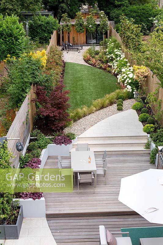 High view of contemporary garden with wood deck patio and artificial lawn Contemporary garden in Dulwich 