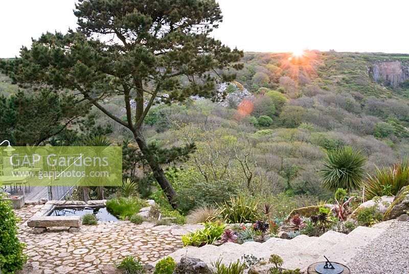 View from top of garden step over landscape as sun rises