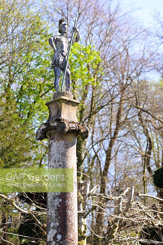 Statue of Roman soldier stands atop an ionic column surveying the landscape beyond. Plas Brondanw, Penrhyndeudraeth, Gwynedd, Wales