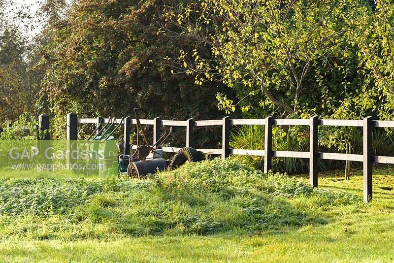 Paddock with gardening equipment  - Thundridge Hill House Garden, Hertfordshire