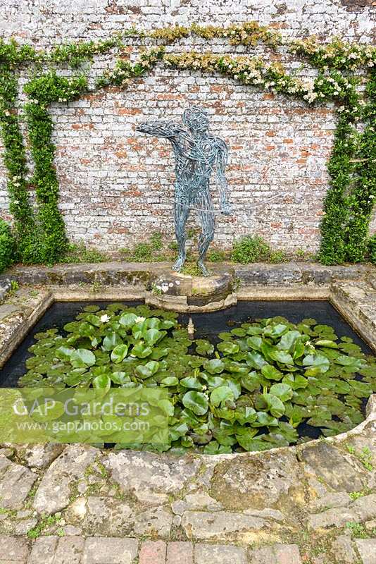 The Demi Lune small pond with waterlilies and Archer Sundial by Robert Rattray.
