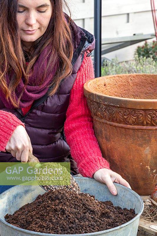 Woman mixing horticultural grit into compost.