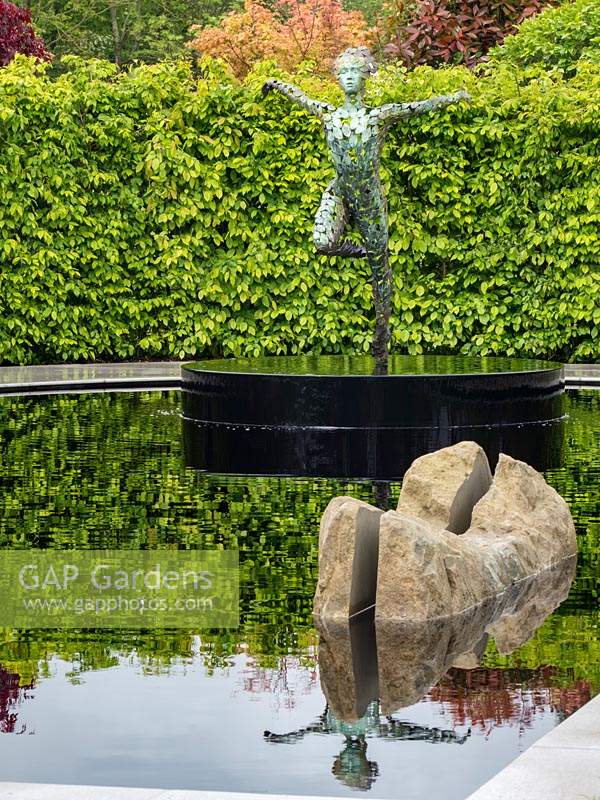 'The Leaf Creative Garden: A Garden of Quiet Contemplation' - view across pond with rock and a sculpture
 by Simon Gudgeon