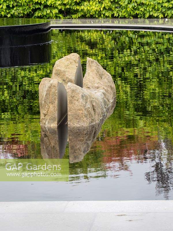 'The Leaf Creative Garden: A Garden of Quiet Contemplation'
 - view across water with a rock  