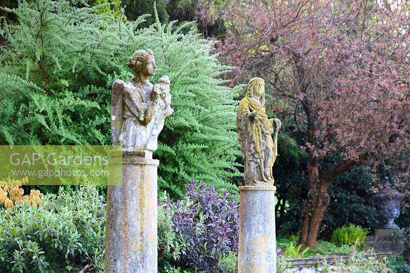 Italian carved stone figures on columns at Iford Manor, Bradford-on-Avon, Wiltshire, UK. 