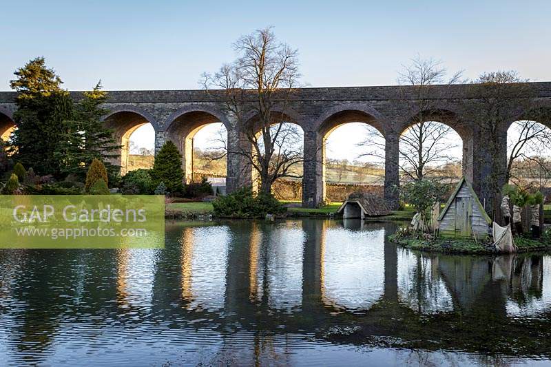 View across lake to viaduct at Kilver Court, Somerset, UK. Designed by Roger Saul of Mulberry. 