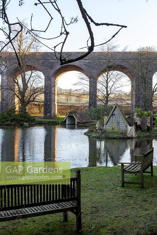 View across lake to viaduct at Kilver Court, Somerset, UK. Designed by Roger Saul of Mulberry.