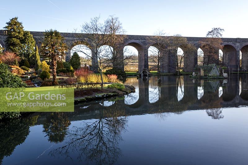 View across lake to viaduct. Kilver Court, Somerset, UK. Designed by Roger Saul of Mulberry.
