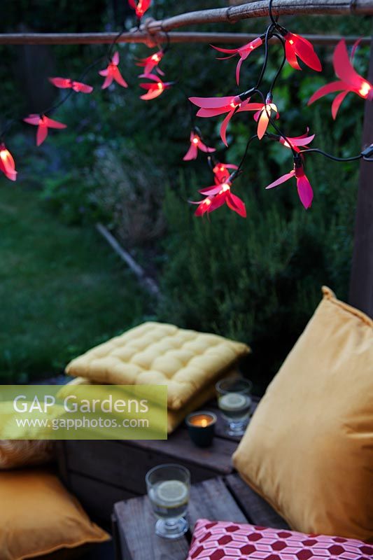 Fairylights decorated with colourful paper shapes to create beautiful decorative outdoor lighting