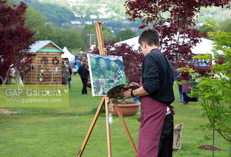 Artist Tom Genders, painting The Leaf Creative Garden by Peter Dowle, RHS Malvern Spring Festival 2019