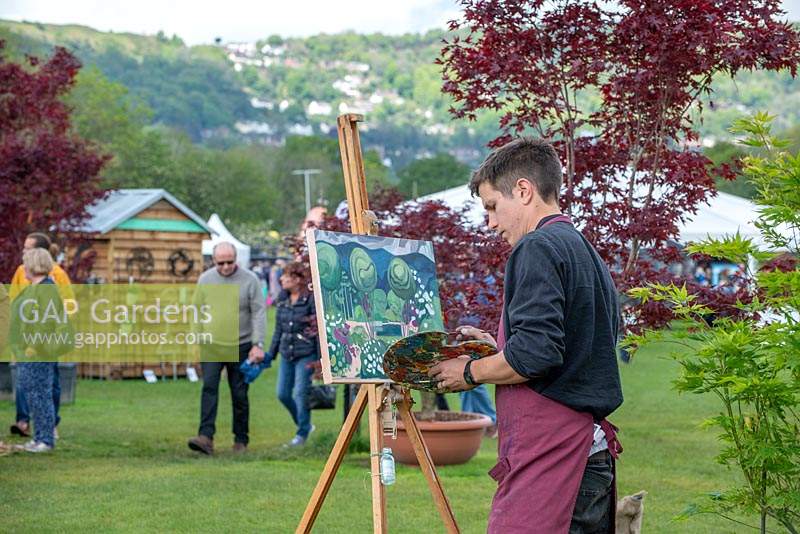 Artist Tom Genders, painting The Leaf Creative Garden by Peter Dowle, RHS Malvern Spring Festival 2019