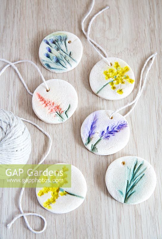 Salt dough gift tags decorated with impressions of flowers then painted 