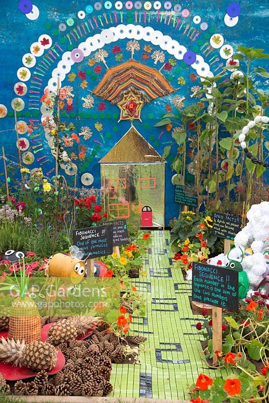Fun and colourful garden with path and borders. 'Aphid' made by pupils at Whirley Primary School. RHS Tatton Flower Show 2019