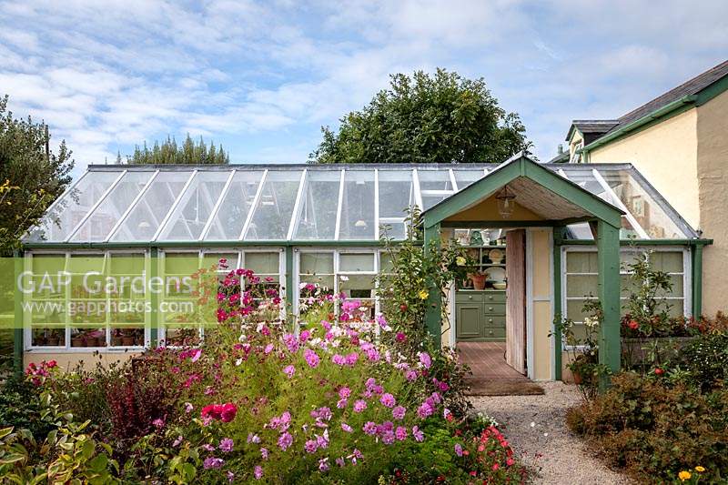 Garden Cottage at Gunwalloe in Cornwall. Cottage garden in autumn. The conservatory