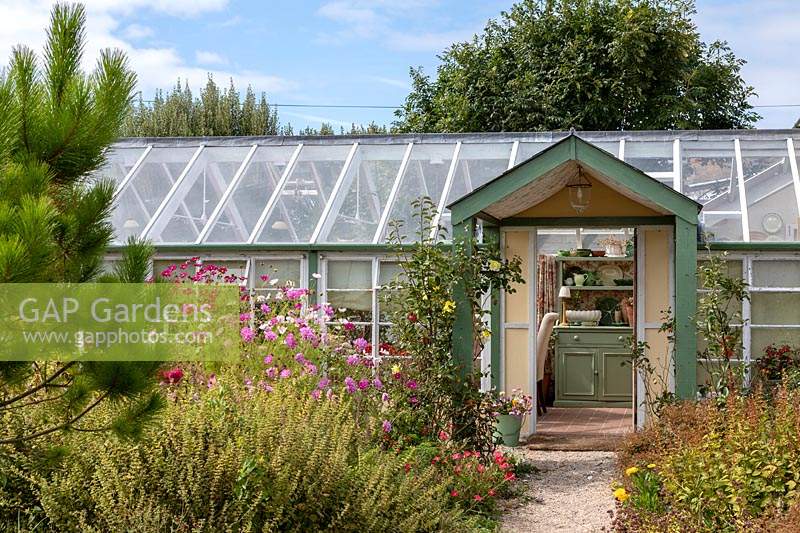 Garden Cottage at Gunwalloe in Cornwall.  Cottage garden in autumn. The conservatory.