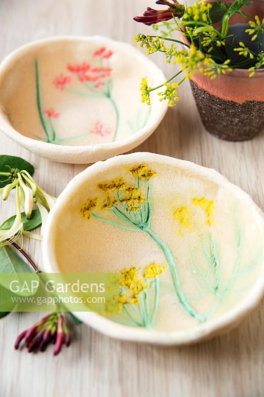 Small bowls made out of salt dough and decorated with painted flower imprints
