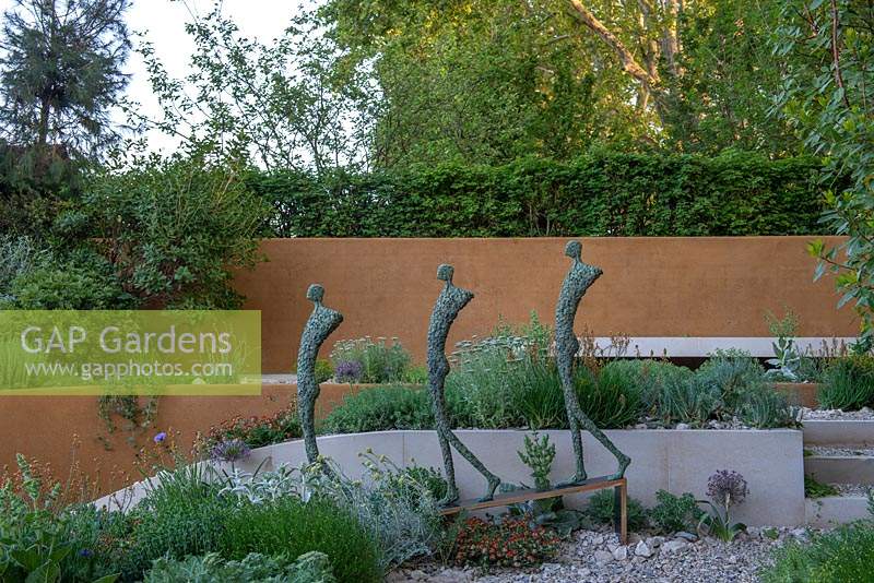 Sculpture of three human figures, designed by Michael Speller - The Dubai Majlis Garden, RHS Chelsea Flower Show 2019.