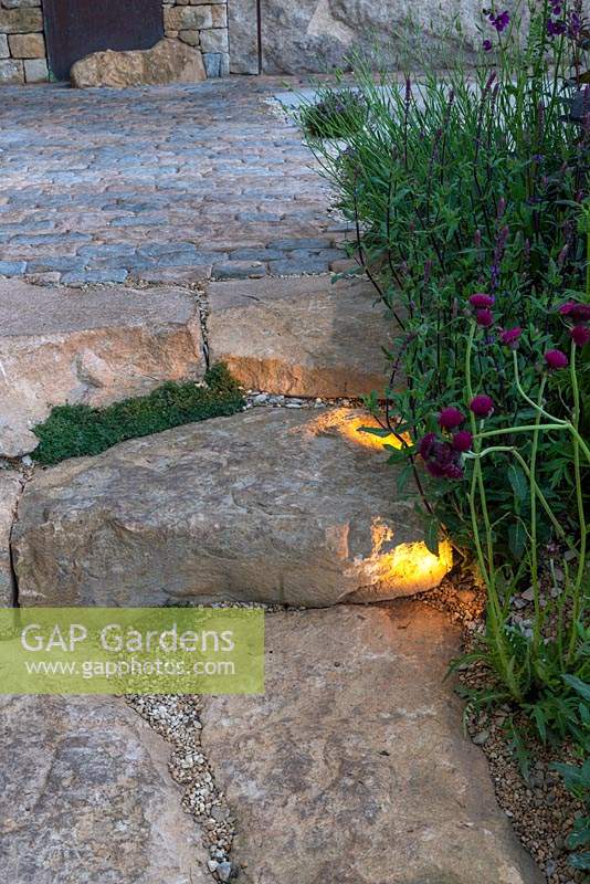 Lighting for stone steps leading to a cobbled patio - The Warner's Distillery Garden, RHS Chelsea Flower Show 2019.