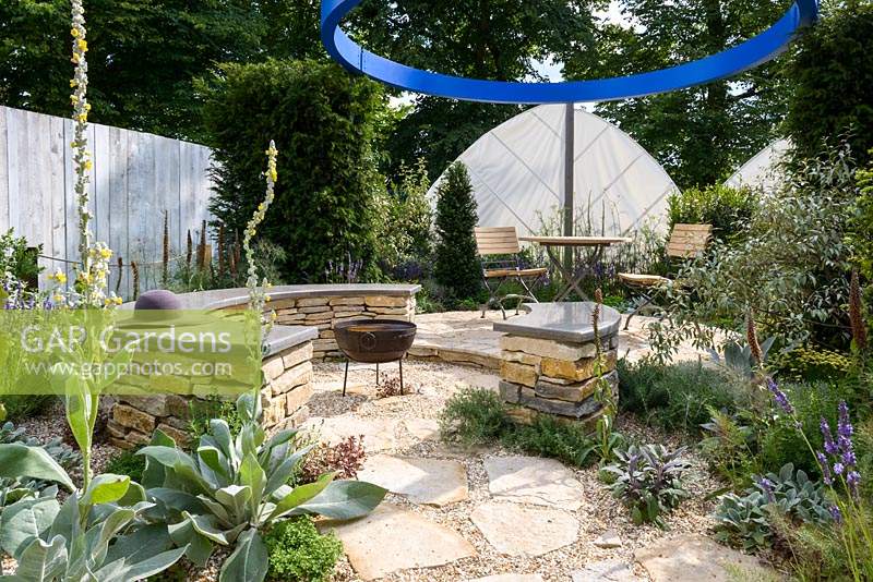 Fire pit and curved wall seats in modern garden with Mediterranean herbs. Halo - RHS Hampton Court Flower Show 2014  