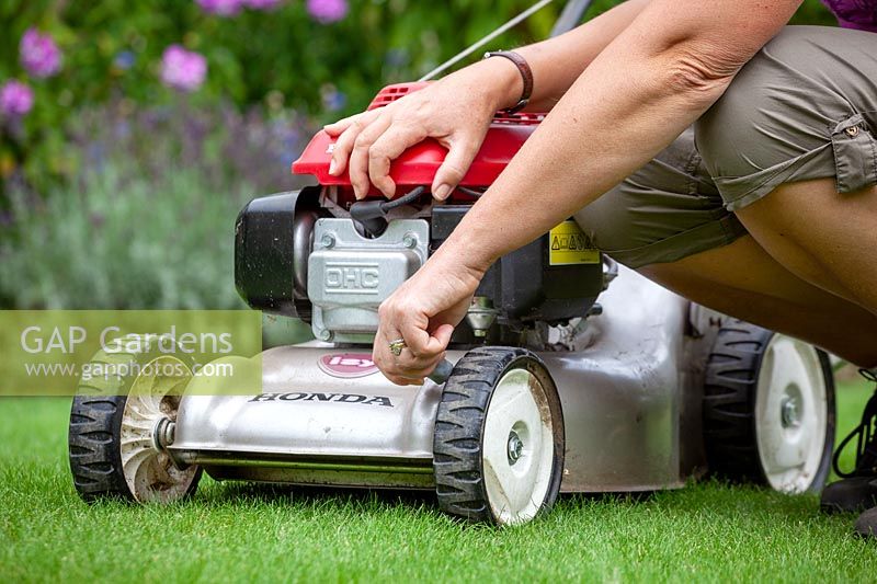 Raising the cutting height of the blades on a lawn mower