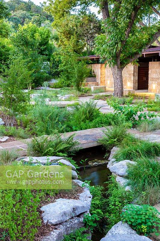 Terraced area with water feature at Mill Creek Ranch in Vanderpool, Texas designed by Ten Eyck Landscape Inc, July.