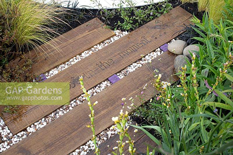 'Find Yourself Lost in the Moment' garden - RHS Chatsworth Flower Show 2019 - view of path showing mixed materials.