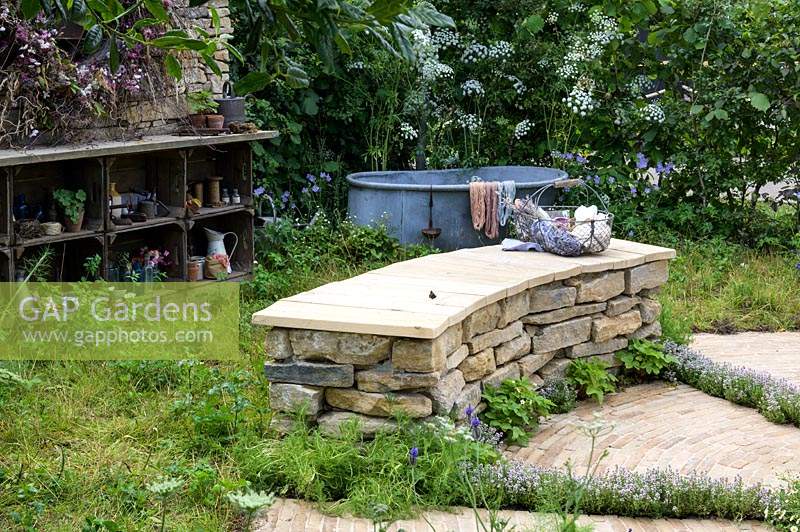 Drystone wall seat and fire pit. The Naturecraft Garden. RHS Hampton Court Palace Garden Festival, 2019.  