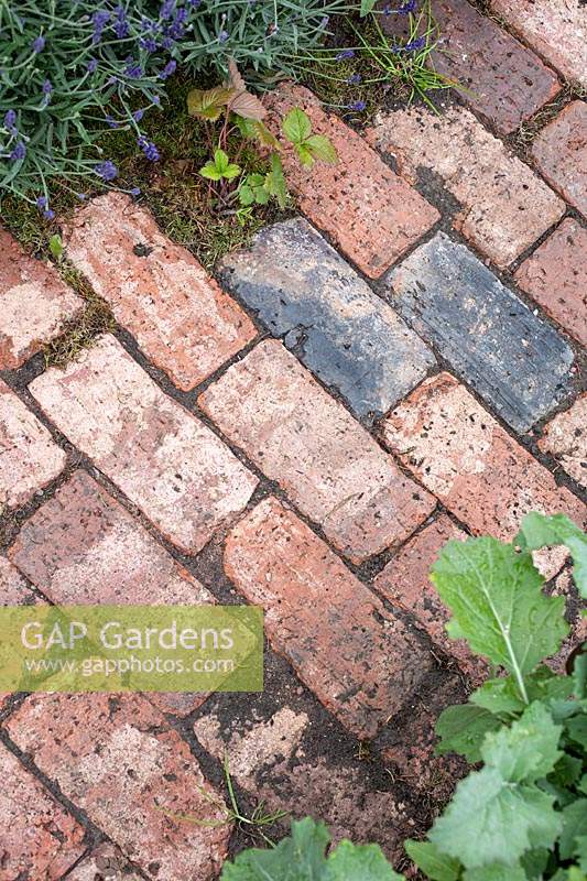 Old brick path in 'An Imagined Miner's Garden', designed by Colin and Mary Bielby at RHS Chatsworth Flower Show, 2019.
