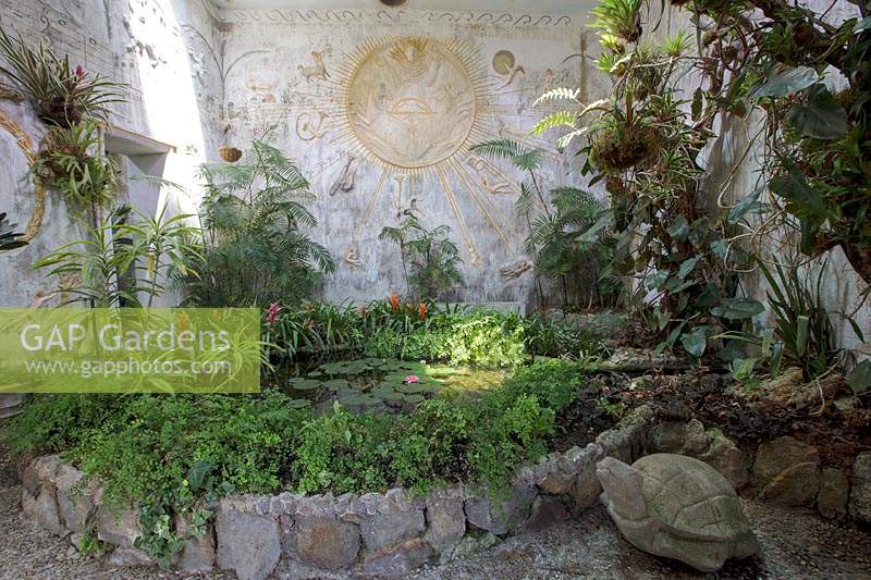 Pond with planting and decoration inspired by mythology dedicated to Apollo. Giardini La Mortella, Isle of Ischia, Italy. Temple of the Sun, Tempio del Sole. 