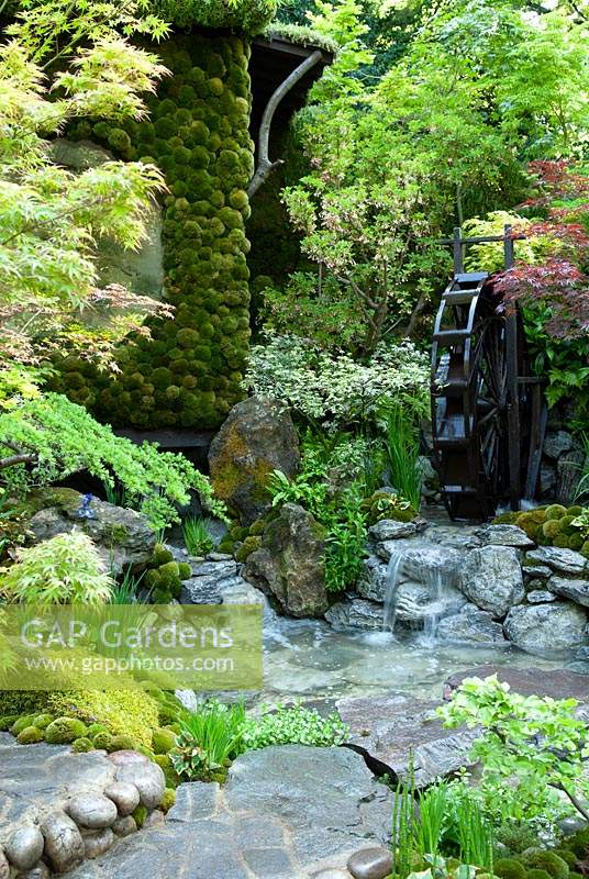 Japanese garden with stream and water wheel, depicting paradise and tranquility - RHS Chelsea Flower Show 2014