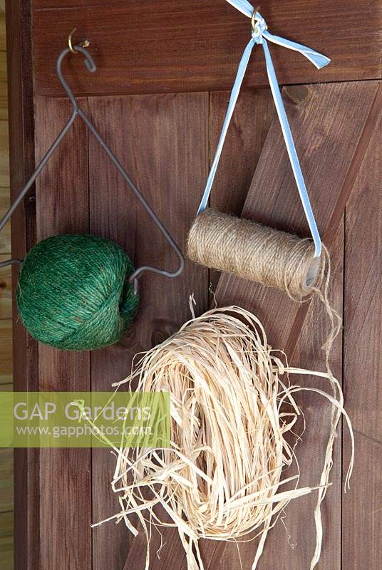 Garden twine and raffia hanging on shed door