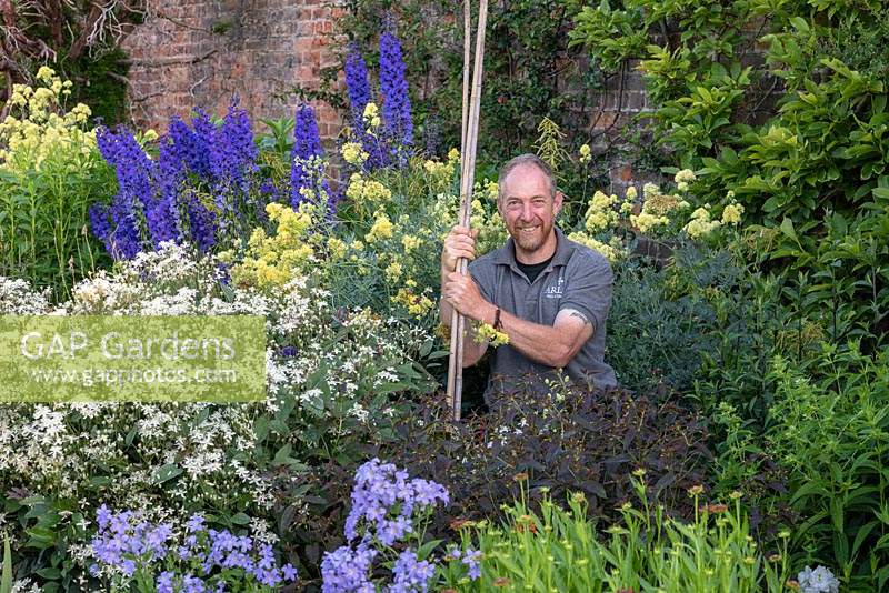 Gordon Baillie, head gardener at Arley Hall, standing in the herbaceous borders.