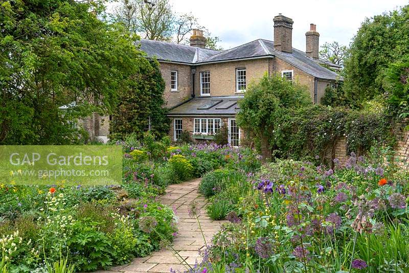 An old rectory built in 1827, and now at the heart of a four-acre garden with open vistas and overflowing beds that make for a relaxed natural feel.