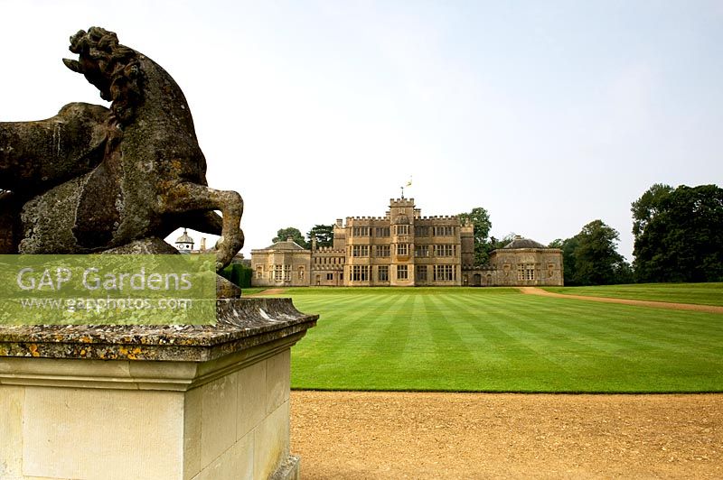 Statue and view of Rousham House over expansive lawn