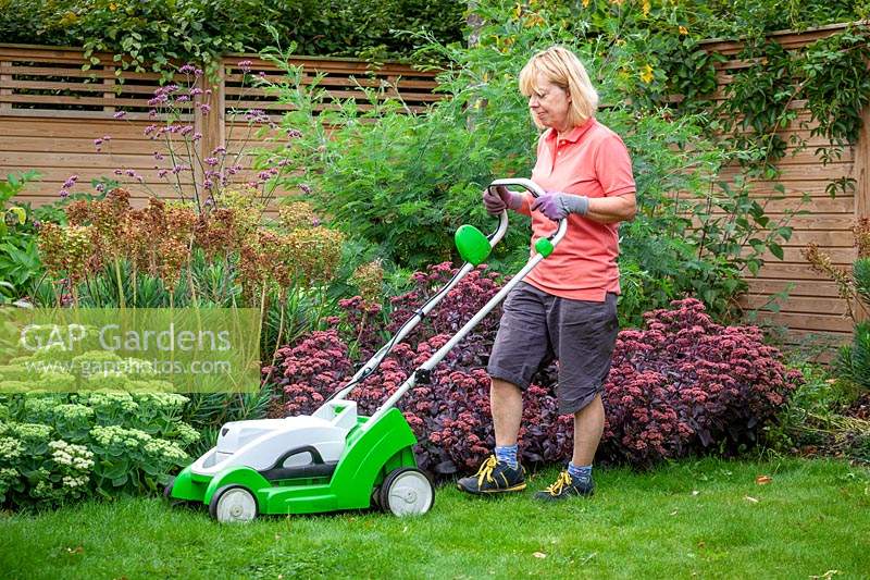 Raising the height of lawnmower blades before cutting a lawn during a dry spell